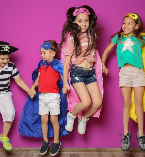 Playful little children in cute costumes indoors